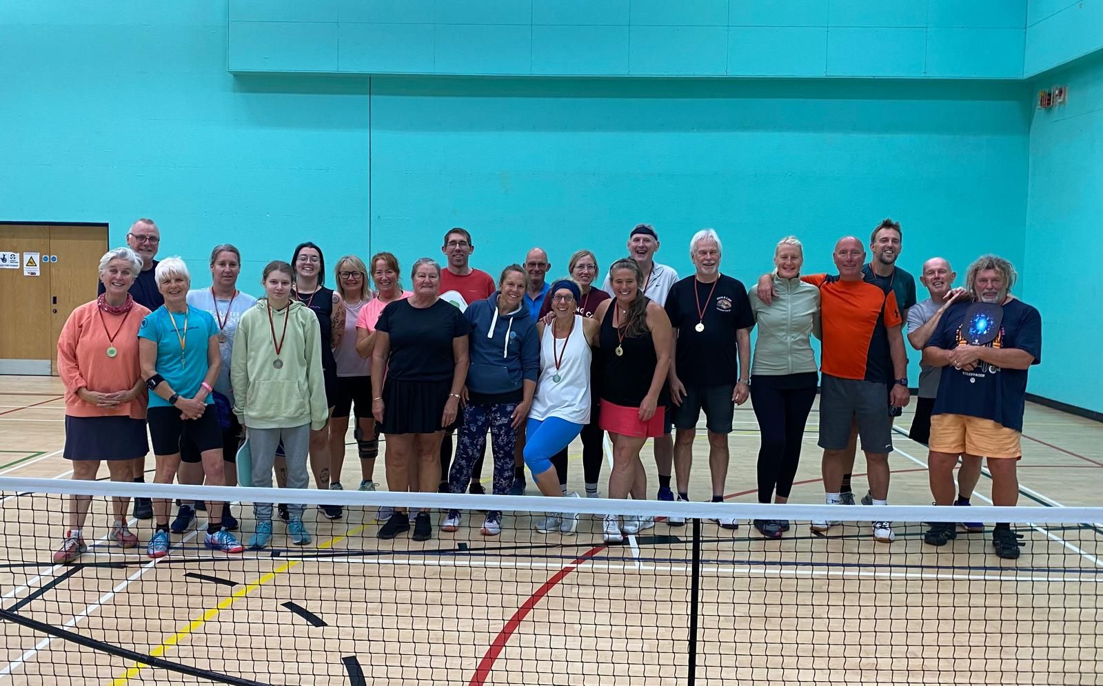 Members of First & Last Pickleball Club gathered on court.